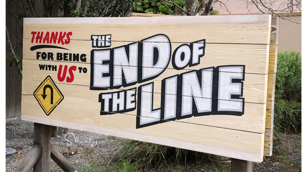 theme park sign indicating the end of the line for an employee