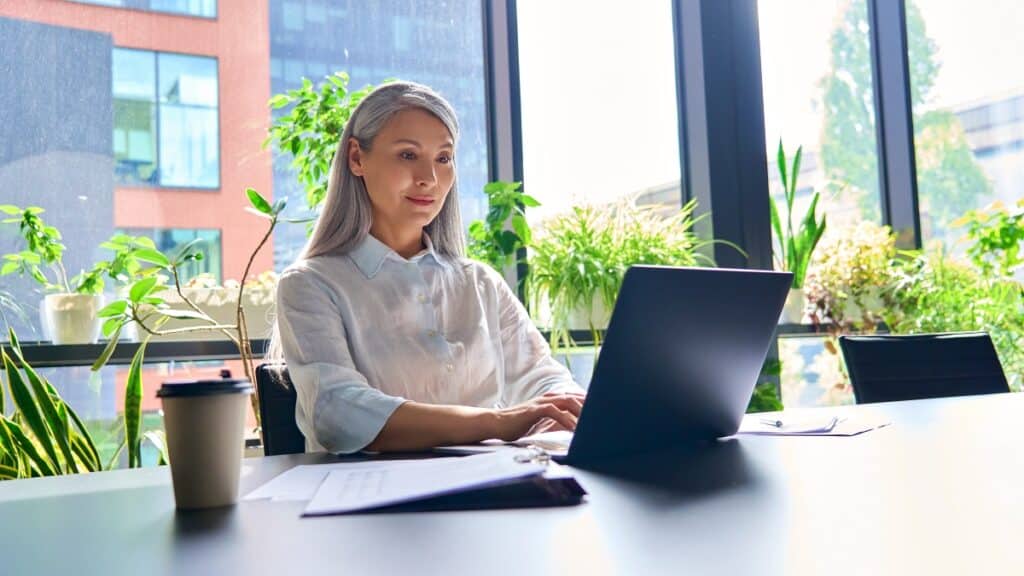 happy confident senior businesswoman reading about perimenopause and menopause