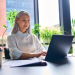 happy confident senior businesswoman reading about perimenopause and menopause